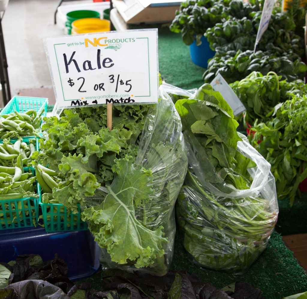 On a table at a farmer's market sits multiple bags of greens. One bag says Kale, $2 or 3/$5. Could these leaves be used if one were to run out of diapers?